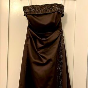 Lovely strapless longformal dress. intricate beading on  left front and at top.